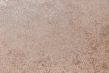 Dokulu arka plan. Dekoratif alçı duvarlar, dış cephe dekorasyonu. Bej rengi, pembe.