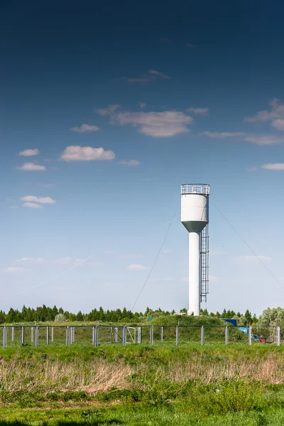 Vattentornet målad i vitt mot blå himmel — Stockfoto