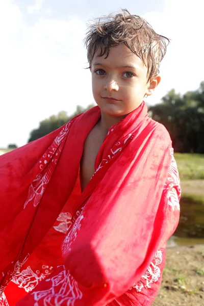 Beautiful boy portrait in red towel outdoors — Stock Photo, Image