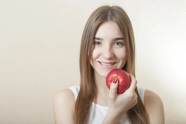 Hermosa mujer rubia sosteniendo una manzana roja — Foto de Stock