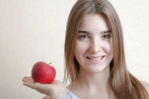 Hermosa mujer rubia sosteniendo una manzana roja — Foto de Stock