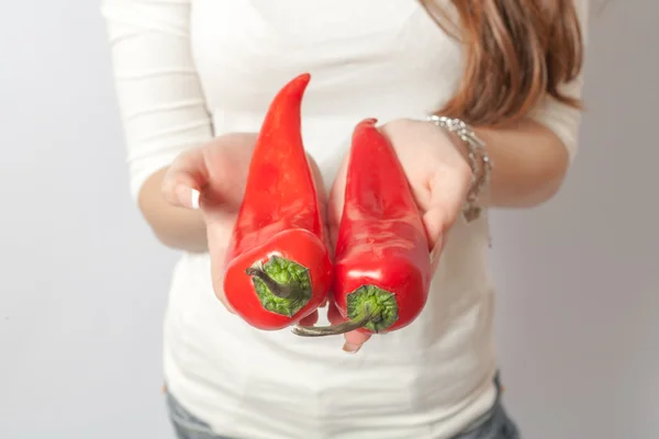 Red peppers in hands — Stock Photo, Image