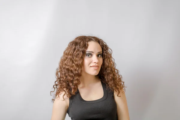 Curly brunette on white background — Stock Photo, Image