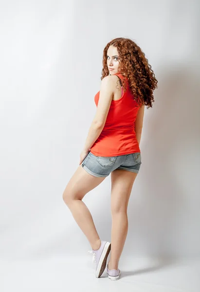 Back view young woman in red shirt. Rear view — Stock Photo, Image
