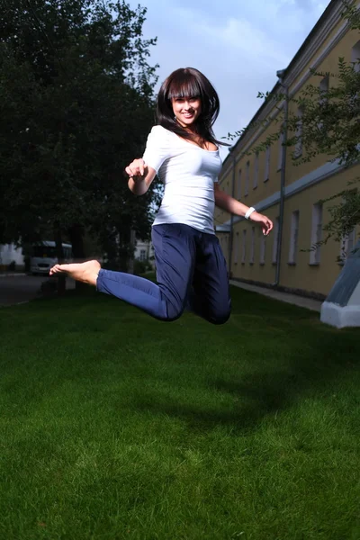 Jumping pretty brunette girl — Stock Photo, Image