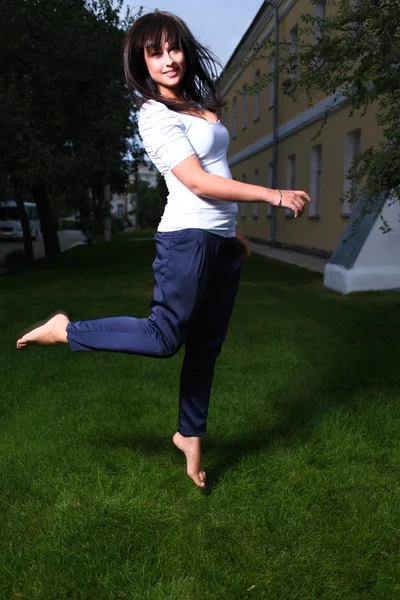 Jumping pretty brunette girl — Stock Photo, Image