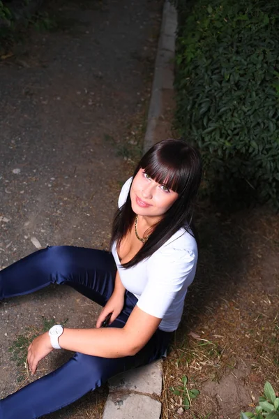 Young beautiful thoughtful girl sitting — Stock Photo, Image