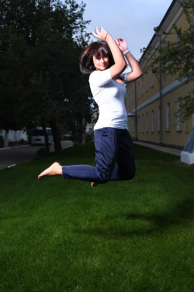 Jumping pretty brunette girl — Stock Photo, Image