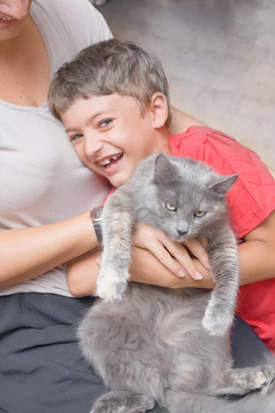 Mother and son with cat having fun. — Stock Photo, Image