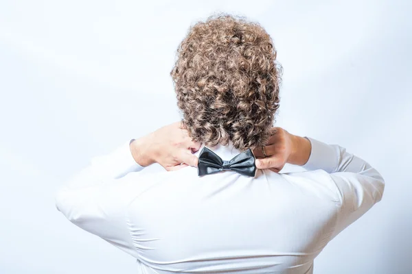 Bow tie on the back side. Strange or fun concept. Back view of an elegant young fashion man in tuxedo , toned image — Stock Photo, Image