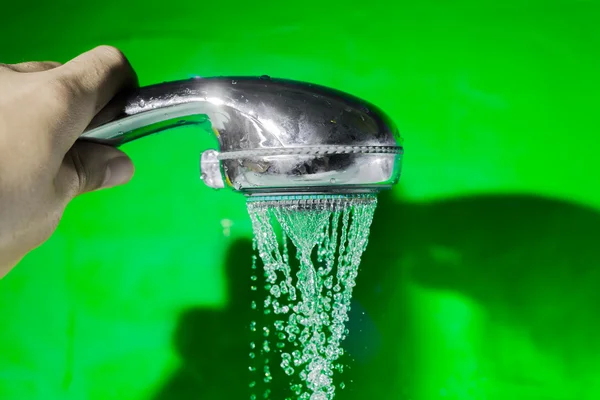 Shower with falling drops of water on the green background. — Stock Photo, Image