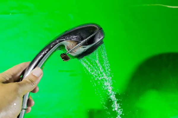 Shower with falling drops of water on the green background. — Stock Photo, Image