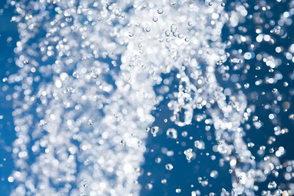 Blauw splash van waterdrops schieten close-up — Stockfoto