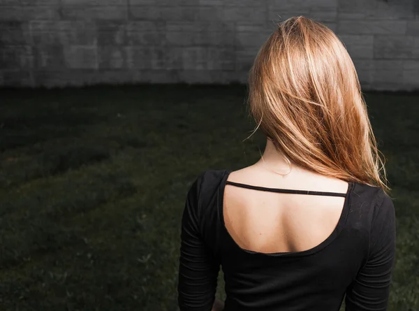 Beautiful young lady at night back view — Stock Photo, Image