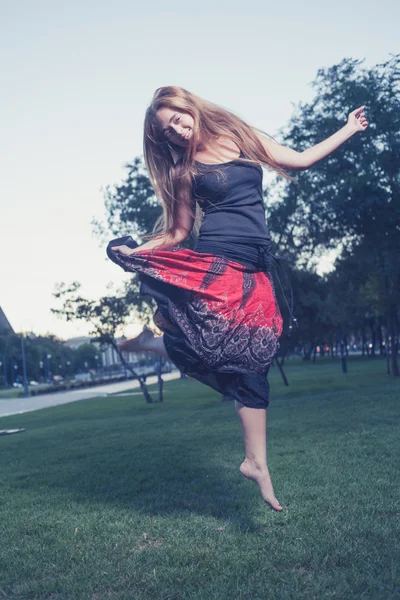 Long haired women jump outdoors at evening — Stock Photo, Image