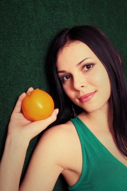 female with an orange in her hands clipart