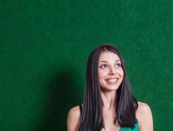 Morena en vestido verde contra la pared — Foto de Stock