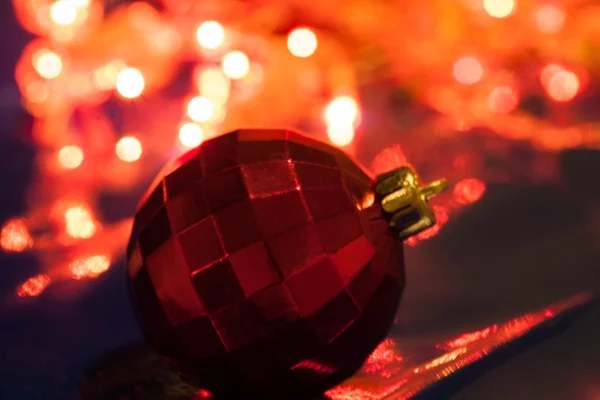 Red ball against xmas lights — Stock Photo, Image