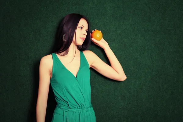 Female with an orange in her hands — Stock Photo, Image