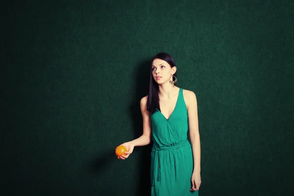 Female with an orange in her hands — Stock Photo, Image