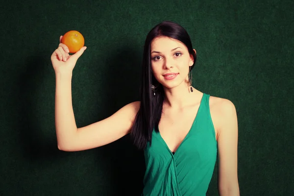 Female with an orange in her hands — Stock Photo, Image