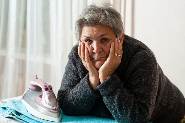 Senior women iron clothes — Stock Photo, Image