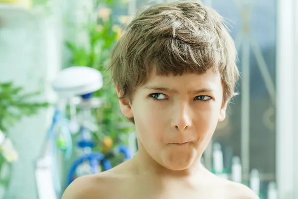 Boy making faces indoors Stock Photo