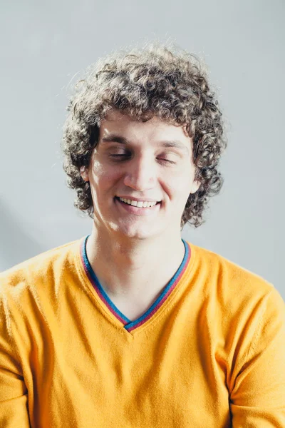 Closed eyes portrait of a young caucasian guy with curly hair — Stock Photo, Image