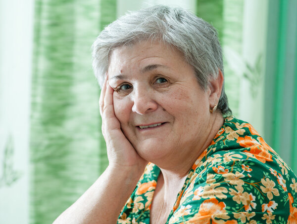 Close up portrait of a happy smiling senior woman