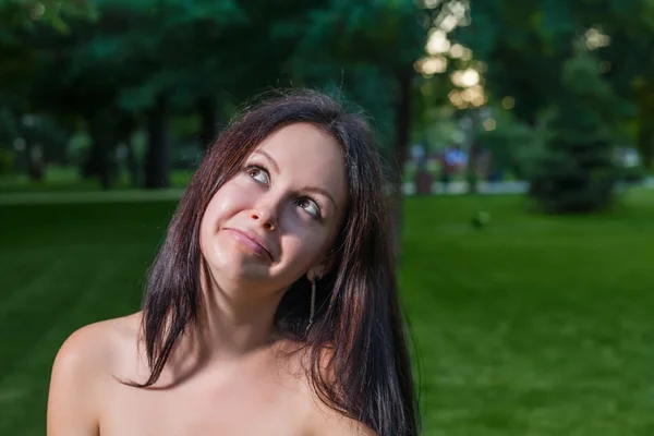 Brunette  grimacing outdoors Stock Picture