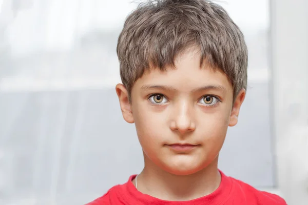 Boy in red shirt indoors closeup — Stock Photo, Image