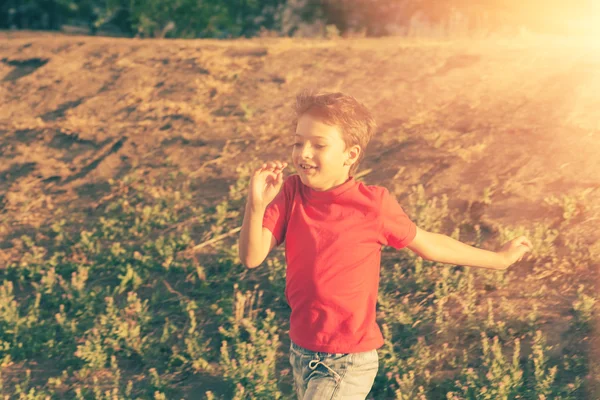 Blurred motion of a boy  running against sun — Stock Photo, Image