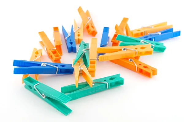 Color clothes-pegs over white — Stock Photo, Image