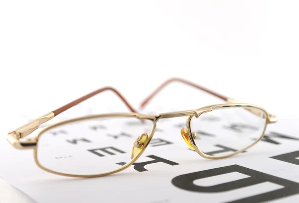Eyeglasses on the ophthalmologic scale. Shallow DOF. — Stock Photo, Image