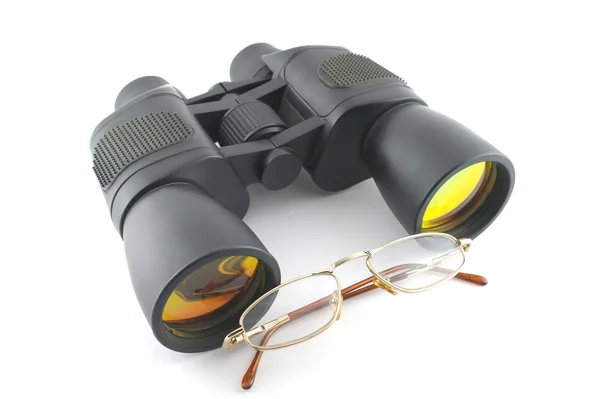 Binoculars and eyeglasses over white — Stock Photo, Image