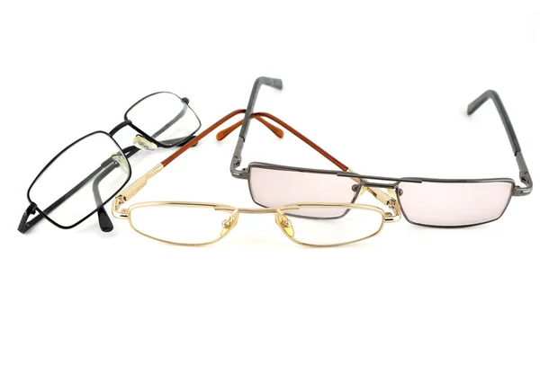 Três óculos ópticos sobre branco — Fotografia de Stock