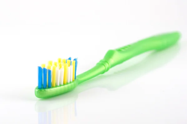 Tooth-brush with green handle over white — Stock Photo, Image