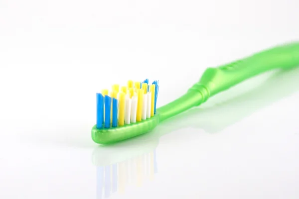 Tandenborstel met groene greep — Stockfoto