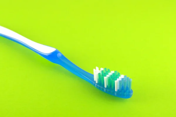 Tooth-brush over bright green — Stock Photo, Image