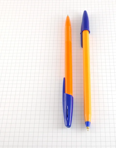 Two pen on the checked paper — Stock Photo, Image