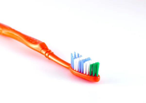 Brosse à dents orange sur blanc — Photo