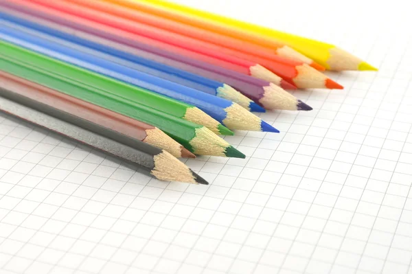 Color pencils on the checked paper — Stock Photo, Image