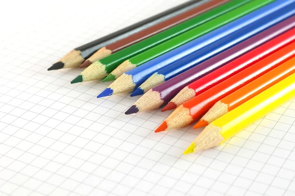 Color pencils on the checked paper — Stock Photo, Image