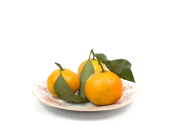 Ripe tangerine on the side plate — Stock Photo, Image