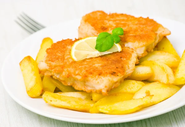 Peixe e batatas fritas com fatia de limão — Fotografia de Stock