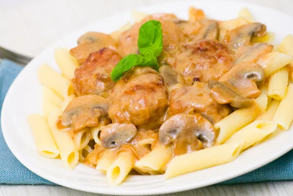 Pasta penne with meatballs and mushroom sauce — Stock Photo, Image