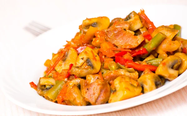 Meat with mushrooms and vegetables — Stock Photo, Image