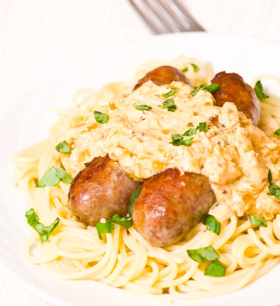 Spaghetti with sausage and sauce — Stock Photo, Image