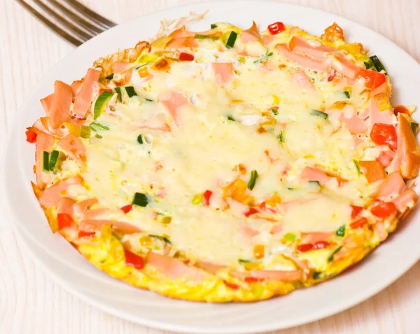 Eggs with vegetables, ham and cheese — Stock Photo, Image