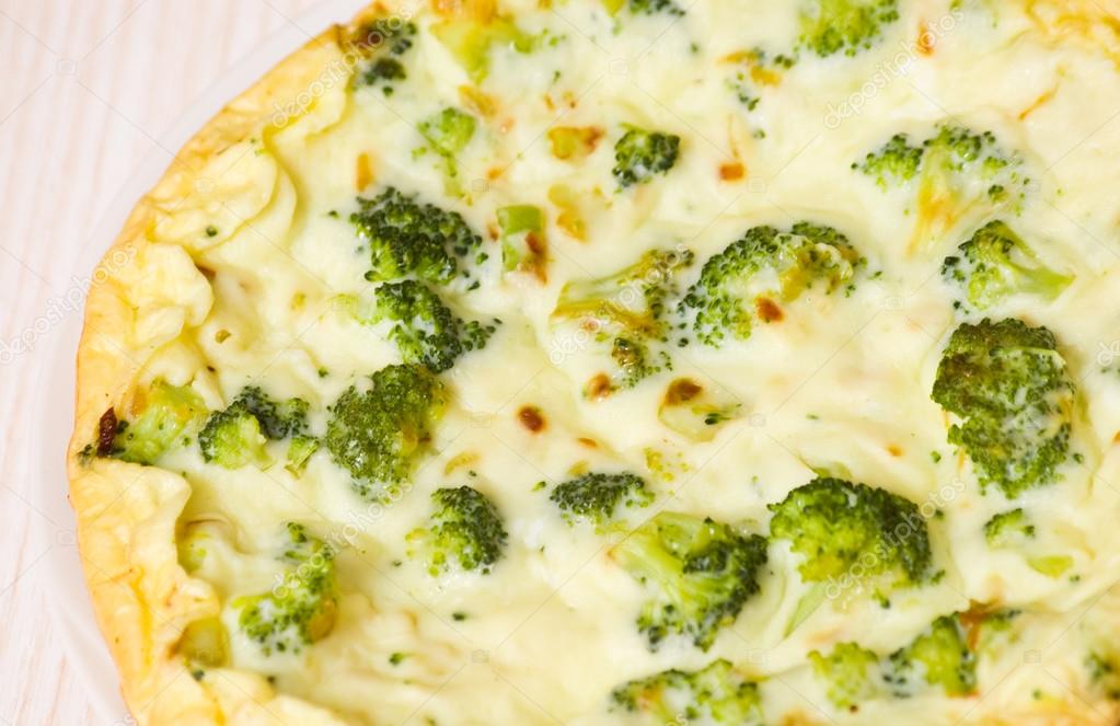 Omelet with cheese and broccoli on a white plate Stock Photo by